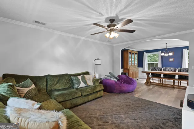 a living room with furniture and kitchen view