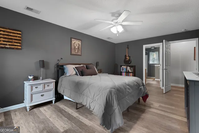 a spacious bedroom with a bed and a chandelier