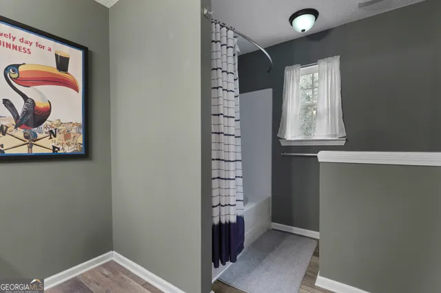 a view of a hallway with paintings on the wall