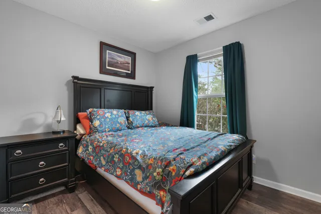 a bed sitting in a bedroom next to a window