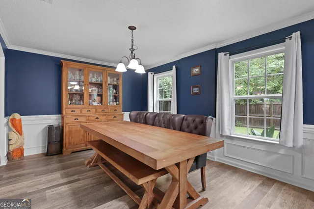 a dining room with a table chairs and entryway
