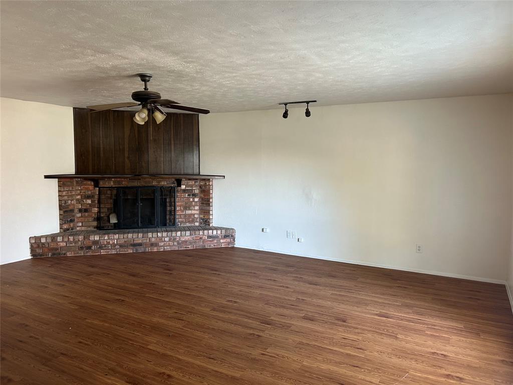 1826 Legend Drive Garland, TX 75040 - Photo 3 of 11 a view of a livingroom with wooden floor and a chandelier