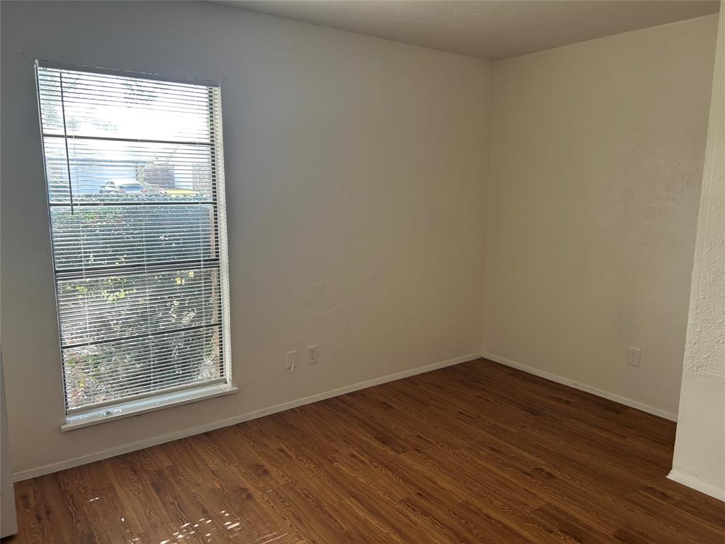 1826 Legend Drive Garland, TX 75040 - Photo 5 of 11 a view of empty room with wooden floor and fan