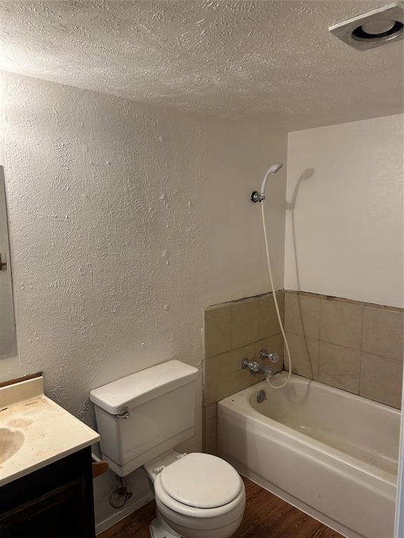 1826 Legend Drive Garland, TX 75040 - Photo 8 of 11 a white toilet and tub sitting next to a bathroom sink