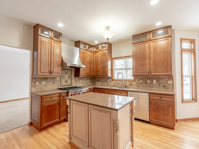 a kitchen with a sink stove and cabinets