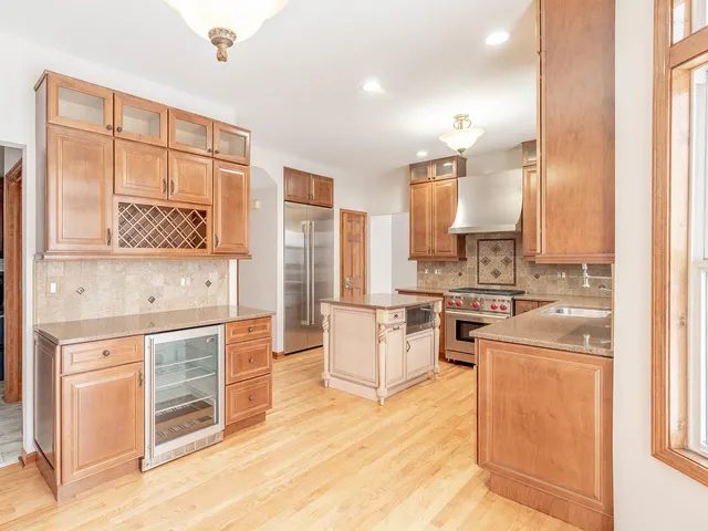 a kitchen with stainless steel appliances a stove a sink and a refrigerator