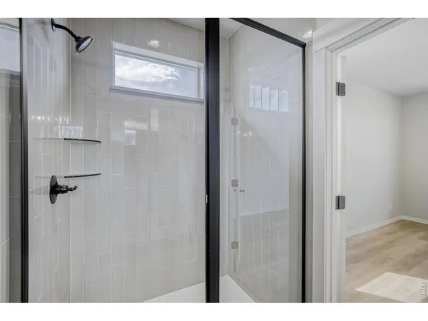 a bathroom with a glass shower door