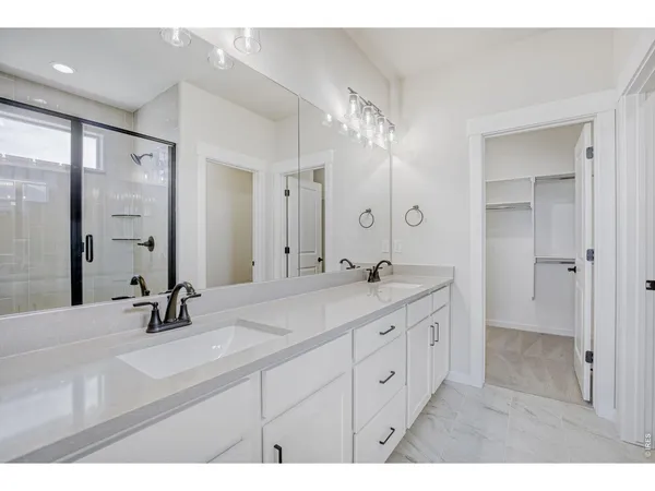 a bathroom with a double vanity sink mirror and