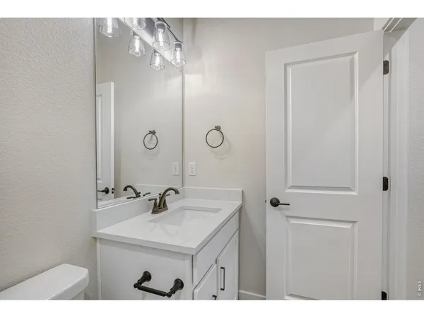 a bathroom with a sink a mirror and shower