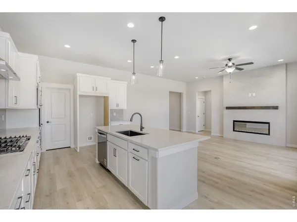 a kitchen with kitchen island a sink stainless steel appliances and cabinets