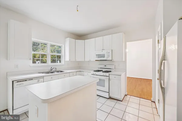 a kitchen with a sink appliances and cabinets