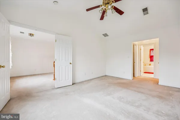 a view of a livingroom with a ceiling fan and window