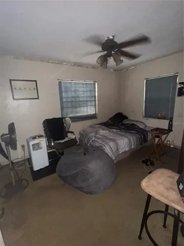 a bedroom with a bed work place and a desk