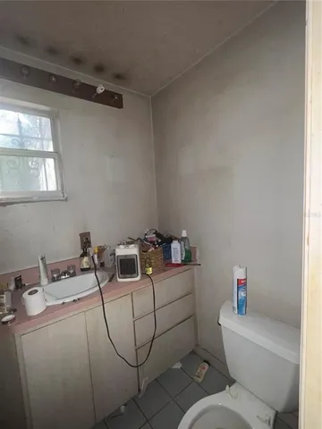 a bathroom with a sink toilet and a mirror