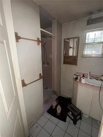 a room with a refrigerator and a stove top oven