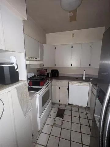 a kitchen with a sink a stove and cabinets