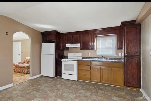 a kitchen with a sink a stove and refrigerator