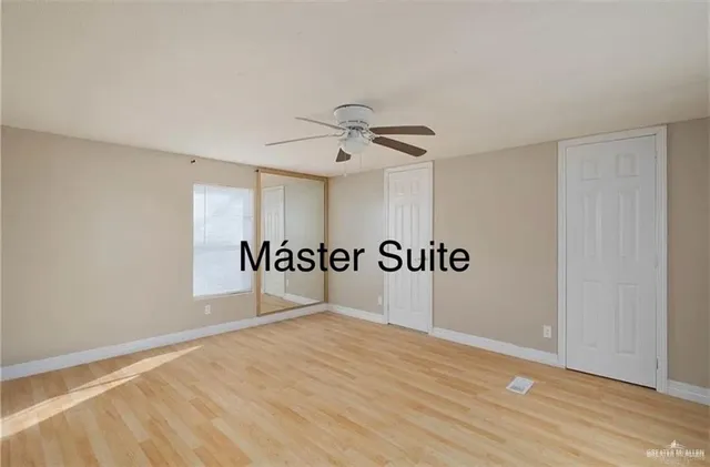 a bathroom with a granite countertop sink a mirror and a toilet