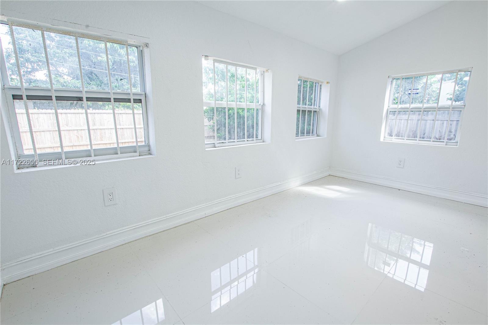 575 Northwest 49th Street Miami, FL 33127 - Photo 13 of 22 a view of empty room with windows