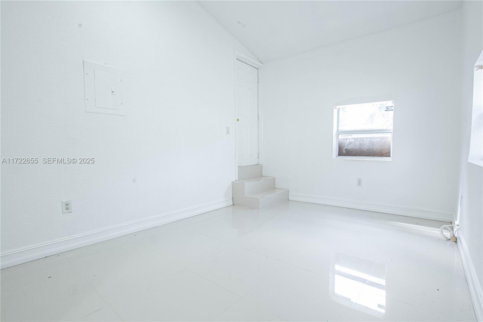 575 Northwest 49th Street Miami, FL 33127 - Photo 17 of 22 an empty room with a window