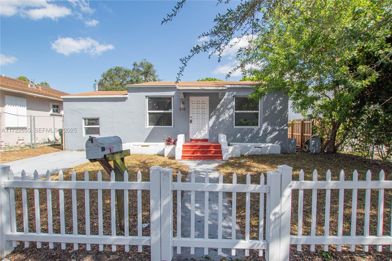 575 Northwest 49th Street Miami, FL 33127 - Photo 18 of 22 a front view of house with car parked