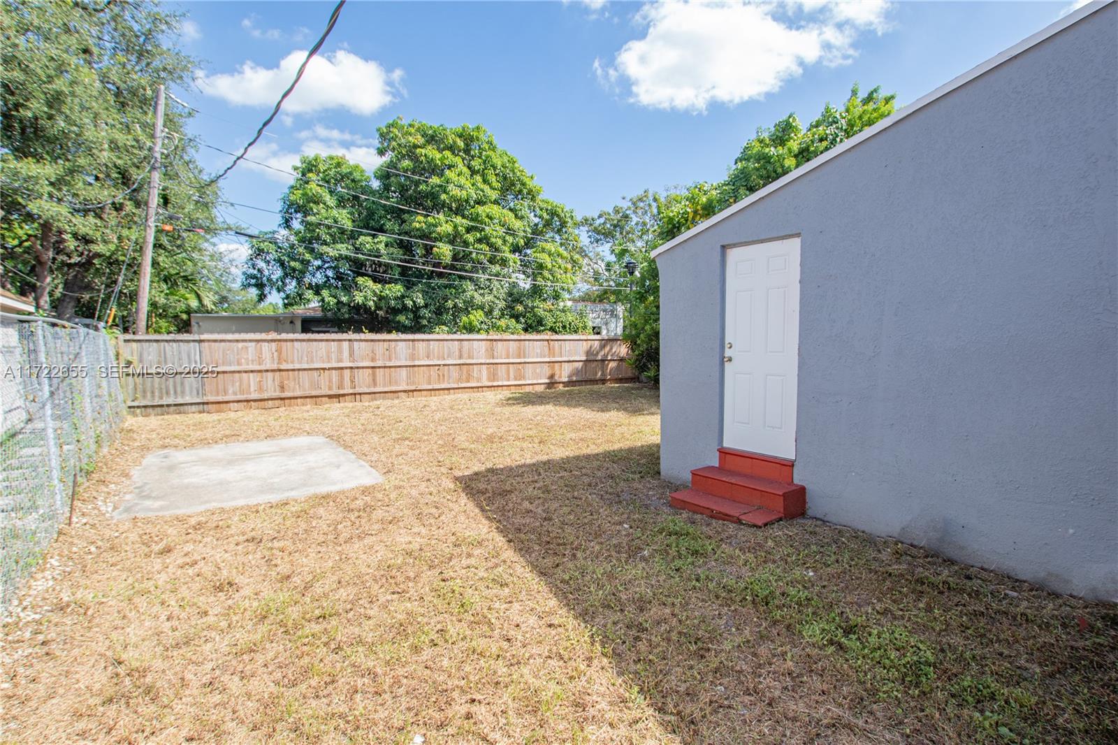 575 Northwest 49th Street Miami, FL 33127 - Photo 20 of 22 a view of backyard and tree