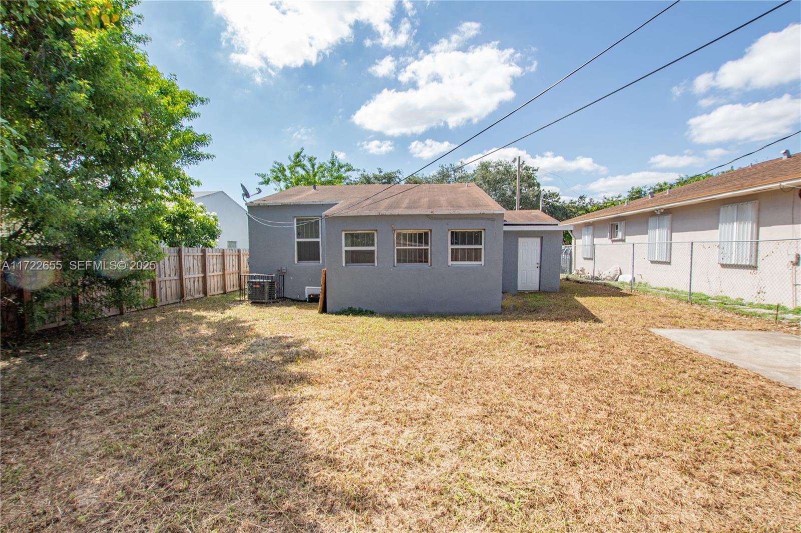 575 Northwest 49th Street Miami, FL 33127 - Photo 21 of 22 a front view of a house with a garden