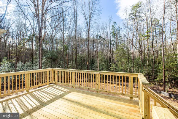 a view of a balcony with wooden floor and fence