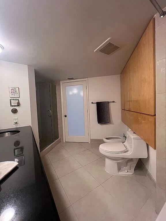 6463 La Costa Drive, Unit 105 Boca Raton, FL 33433 - Photo 23 of 40 a bathroom with a sink a toilet and a mirror