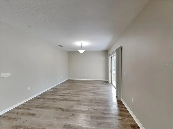 a view of an empty room and wooden floor