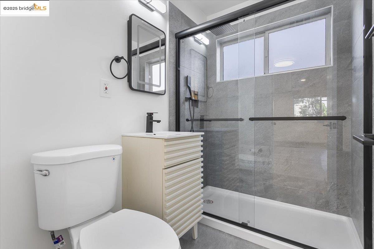 1610 Milvia Street Berkeley, CA 94709 - Photo 14 of 24 a bathroom with a toilet and a shower