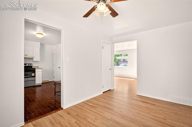 130 South Chelton Road Colorado Springs, CO 80910 - Photo 6 of 17 Dining are off of living room with light wood-style flooring and ceiling fan