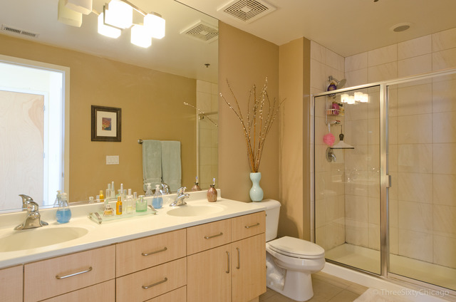 1201 West Adams Street, Unit 905 Chicago, IL 60607 - Photo 13 of 19 a bathroom with a double vanity sink toilet mirror and shower