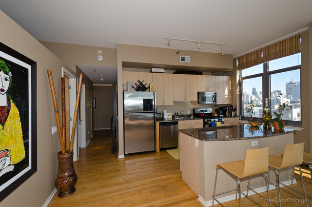 1201 West Adams Street, Unit 905 Chicago, IL 60607 - Photo 4 of 19 a kitchen with refrigerator and cabinets