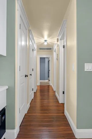 a view of a livingroom with wooden floor and furniture