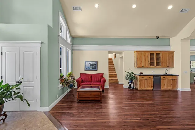 a kitchen with stainless steel appliances granite countertop a stove a sink and a microwave