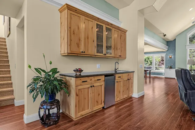 a work room with furniture a flat screen tv and wooden floor