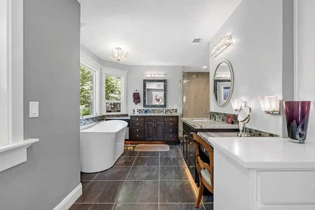 a backyard of a house with a yard and outdoor seating