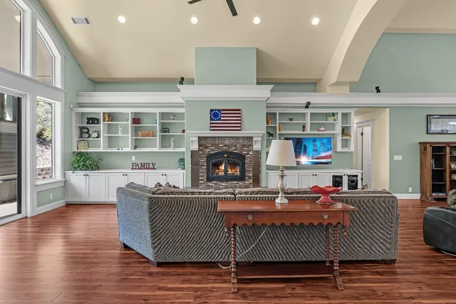 a living room with furniture wooden floor and a fireplace