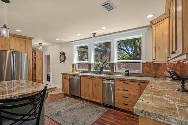 a kitchen with stainless steel appliances granite countertop a lot of counter top space