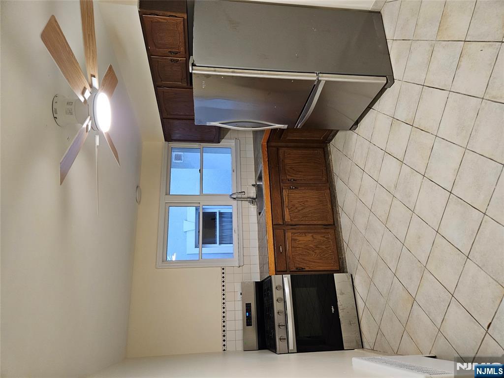 581 High Mountain Road, Unit 1 North Haledon, NJ 07508 - Photo 8 of 9 a kitchen with stainless steel appliances a refrigerator sink and cabinets