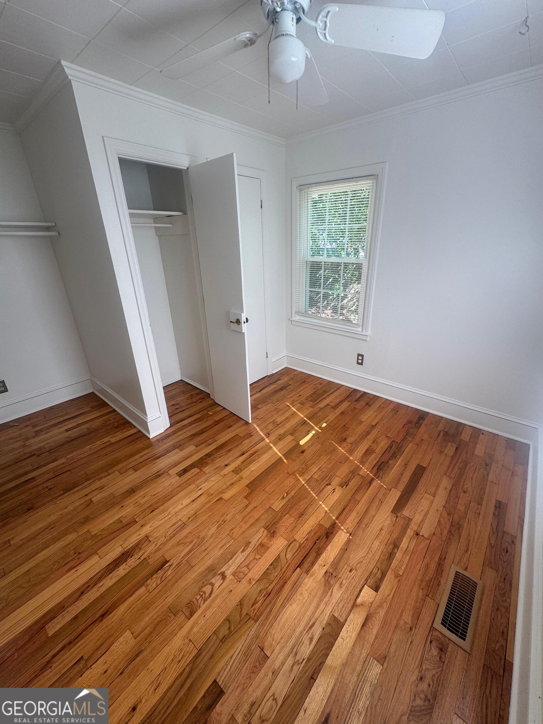 609 West Main Street Thomaston, GA 30286 - Photo 17 of 27 wooden floor in an empty room with a window