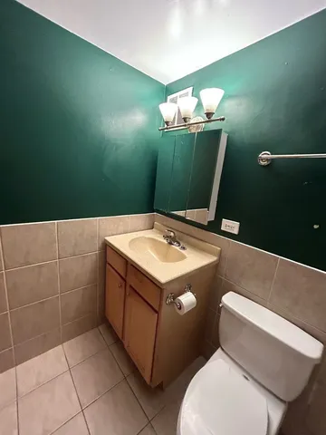 a bathroom with a sink mirror and toilet