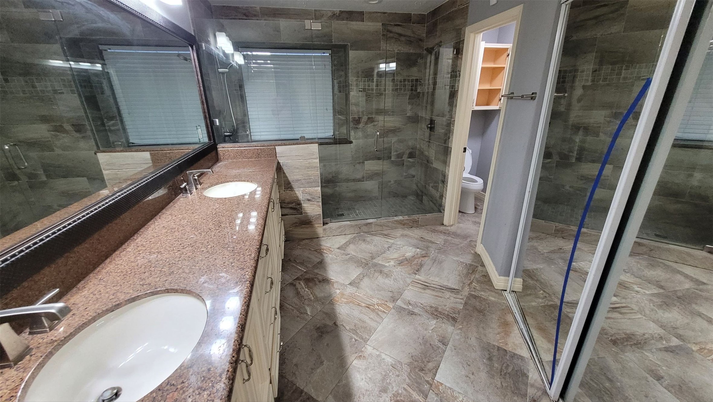 13307 Lynnville Drive Houston, TX 77065 - Photo 5 of 9 a bathroom with a granite countertop shower a sink and a mirror