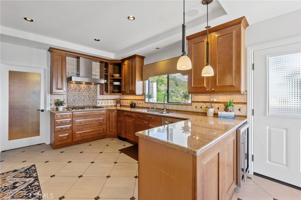 34403 Street Of The Green Lantern, Unit 2 Dana Point, CA 92629 - Photo 12 of 38 a kitchen with a sink a counter top space stainless steel appliances and cabinets
