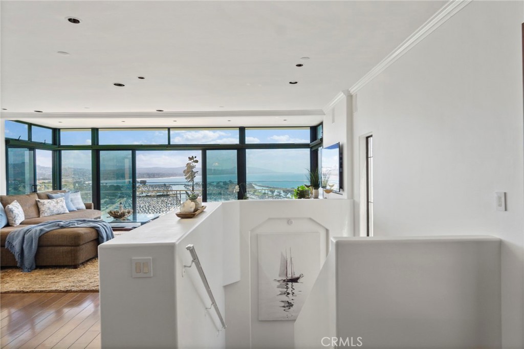 34403 Street Of The Green Lantern, Unit 2 Dana Point, CA 92629 - Photo 14 of 38 a living room with furniture and large windows