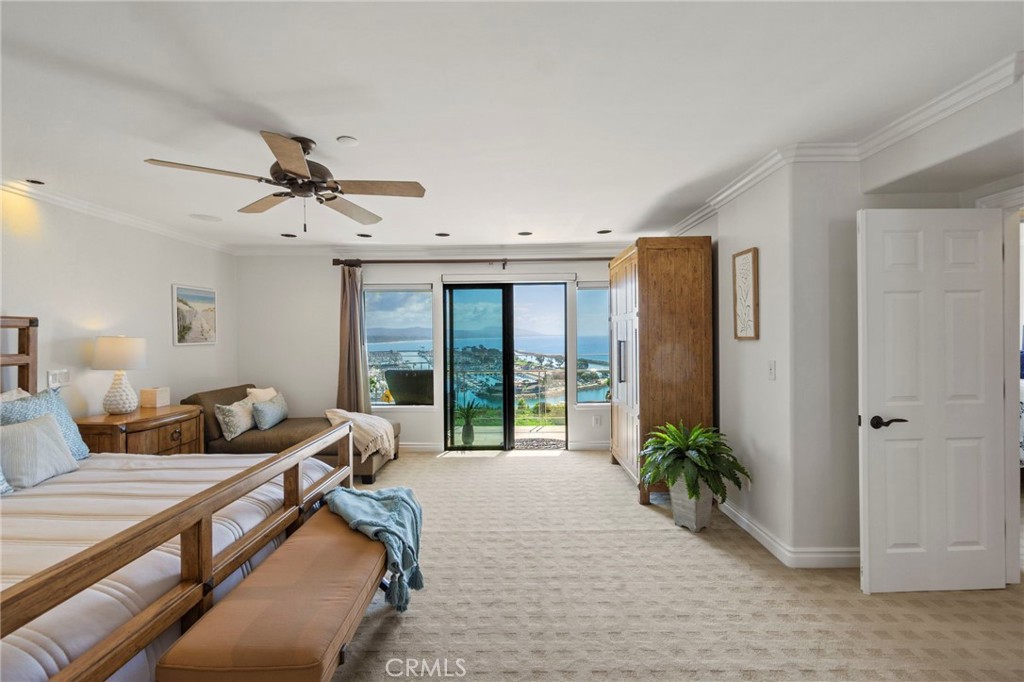 34403 Street Of The Green Lantern, Unit 2 Dana Point, CA 92629 - Photo 15 of 38 a spacious bedroom with a large bed and a chandelier