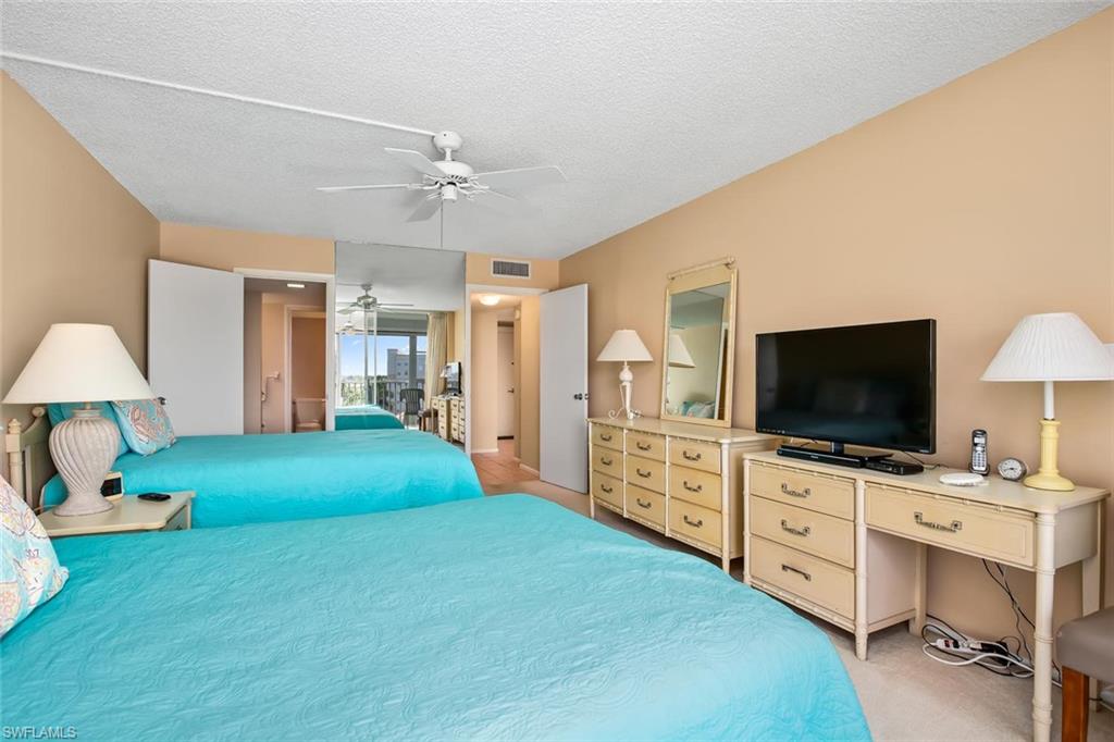 3 Bluebill Avenue, Unit 610 Naples, FL 34108 - Photo 12 of 15 a room with furniture and a flat screen tv