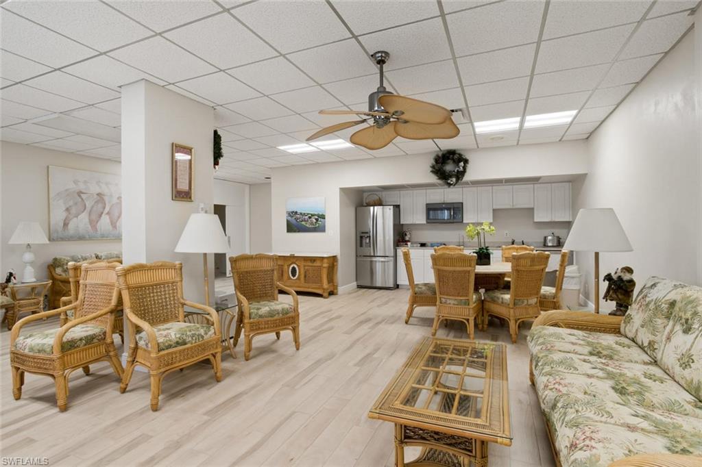 3 Bluebill Avenue, Unit 610 Naples, FL 34108 - Photo 15 of 15 a living room with lots of furniture and wooden floors