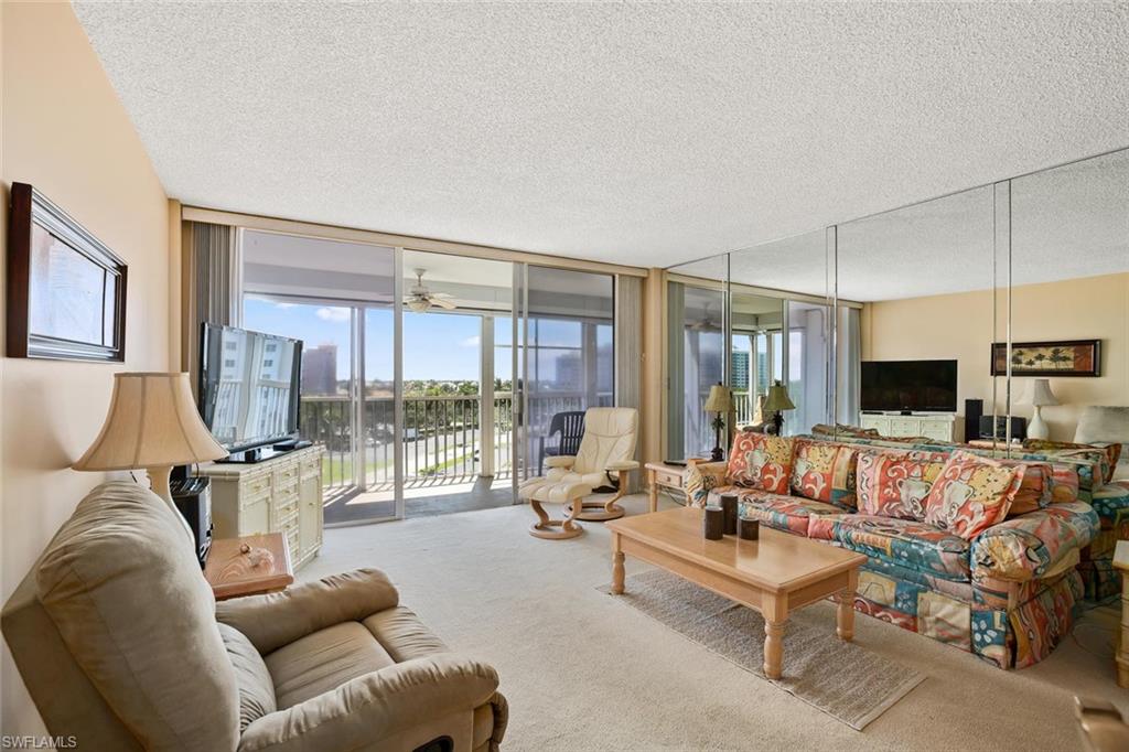 3 Bluebill Avenue, Unit 610 Naples, FL 34108 - Photo 4 of 15 a living room with furniture and a large window